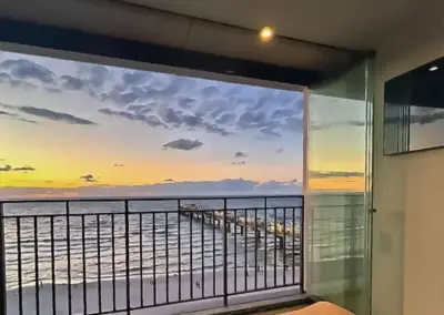 Balkon mit Blick auf die Seebrücke von Misdroy bei Sonnenuntergang, Ostsee-Panorama mit Abendstimmung.
