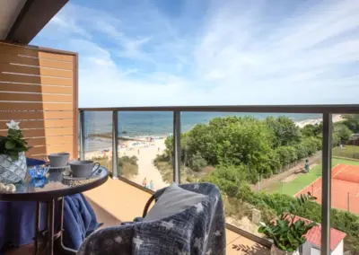 Balkon des Ferienappartements in Dziwnów mit Blick auf die Ostsee und den angrenzenden Tennisplatz.