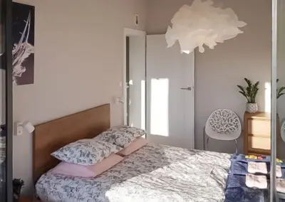 Gemütliches Schlafzimmer im Ferienappartement Dziwnów mit Doppelbett, Tageslicht und stilvoller Einrichtung.